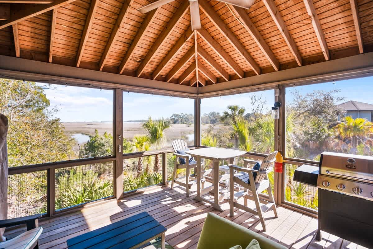 Lovely outdoor screened in living area with spectacular marsh views