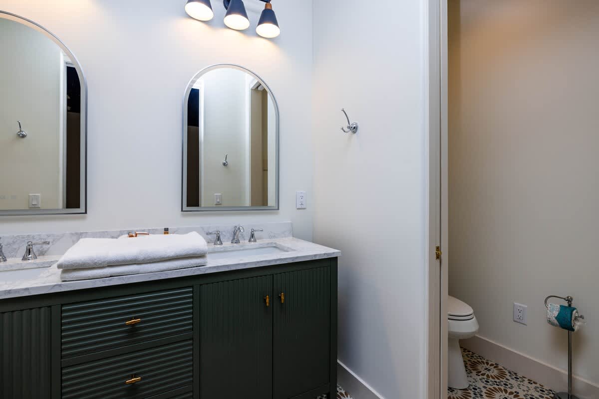 Bunk Bedroom En-Suite with Double Vanity and Shower Tub Combo 