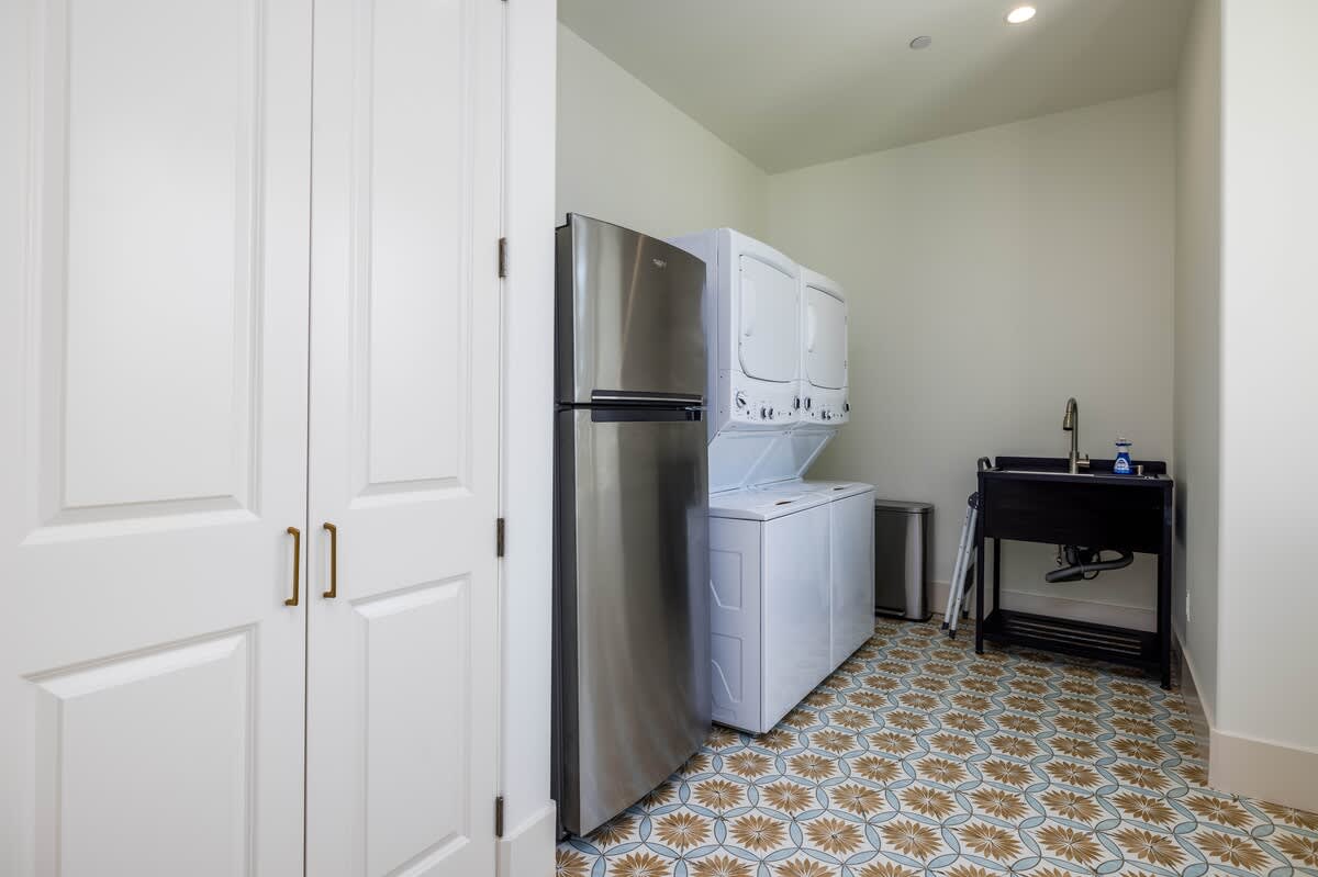 Laundry Room with 2 Washer and Dryers and an Additional Fridge 