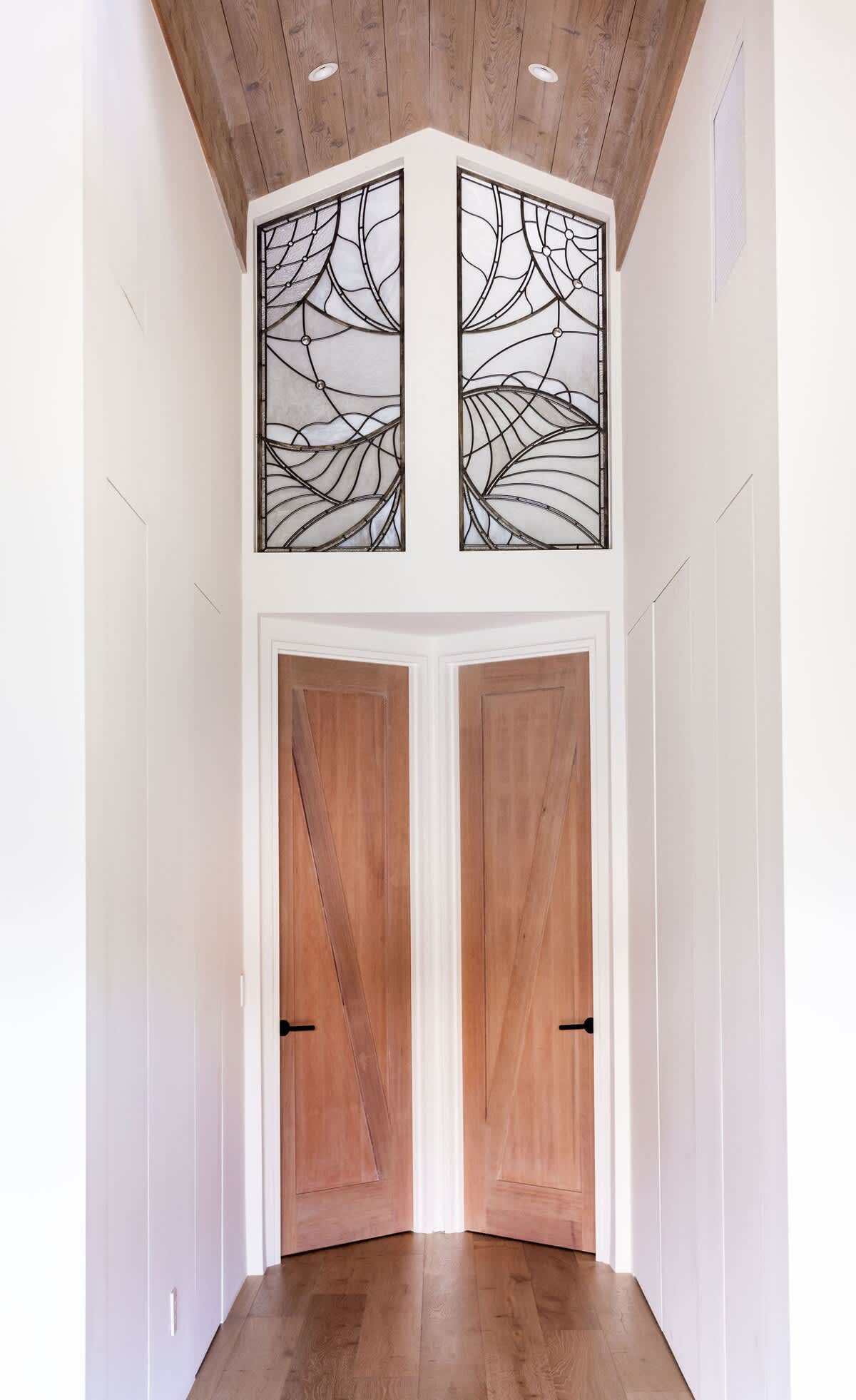 The walkway leading to the bedrooms, with the pantry rack, powder room, washing machines, and mini library with books and board games