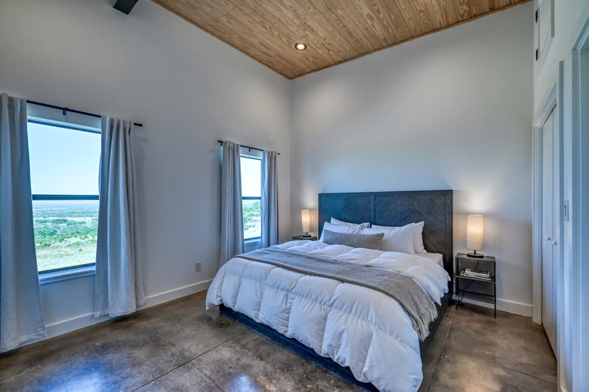 Experience a peaceful night's sleep in our luxurious master bedroom, featuring a comfortable king bed.