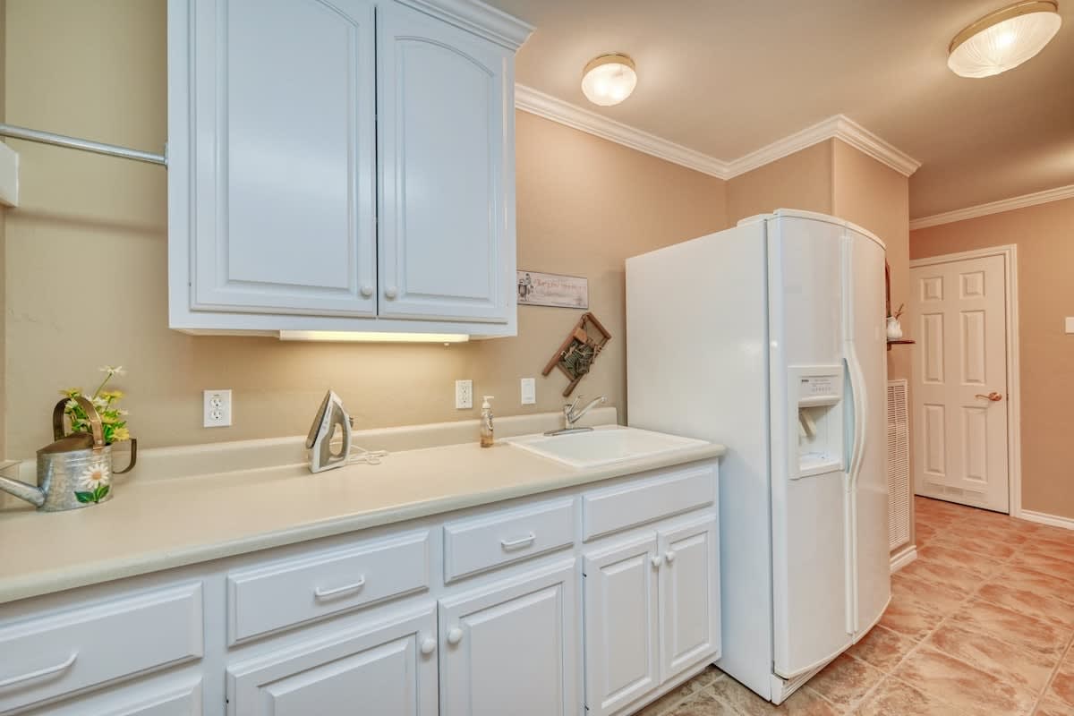Additional counter space and fridge in the laundry room.