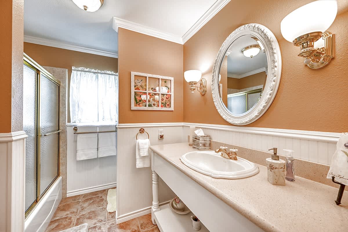 Shared bathroom with tub/shower combo.