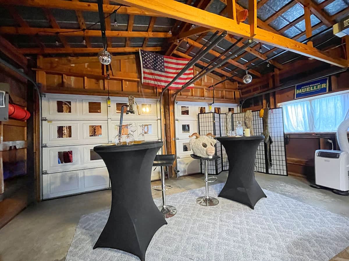 Garage Game room offers tables and chairs to gather.