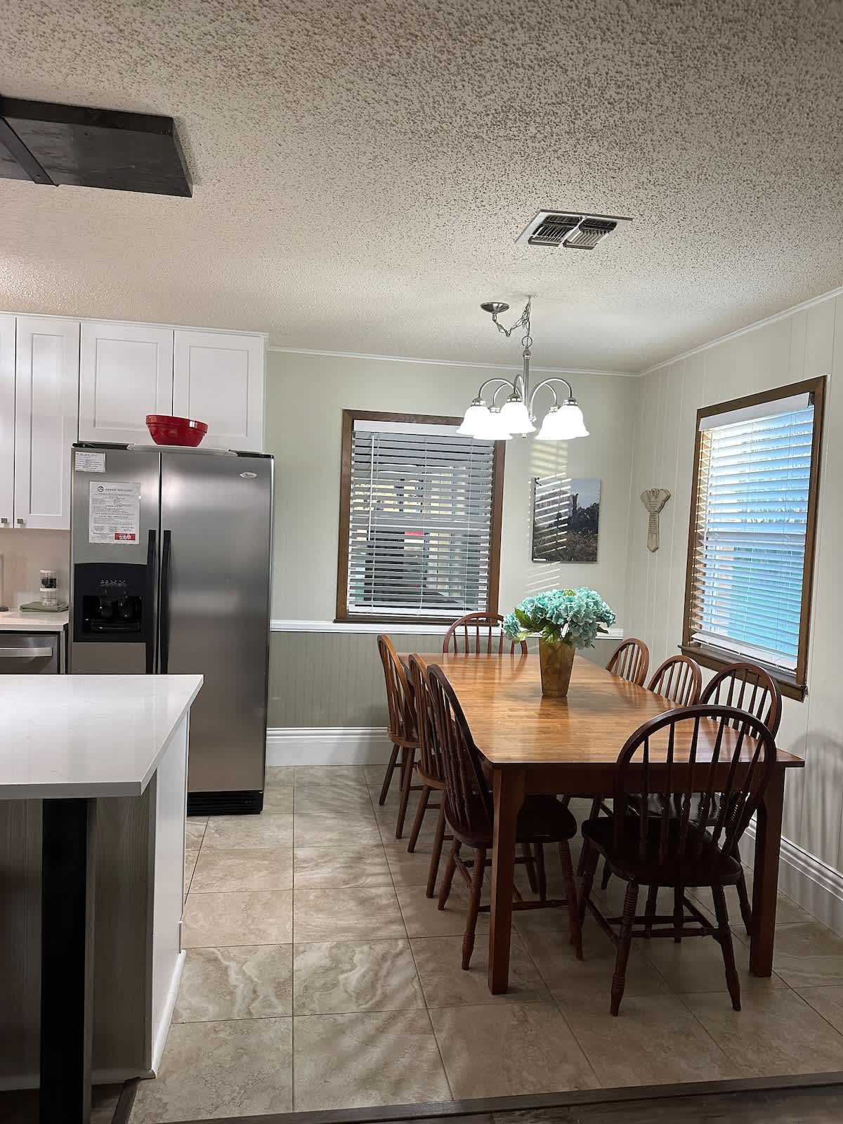 Spacious dining table comfortably accommodates 8 guests with ample room for serving dishes and a stylish centerpiece.