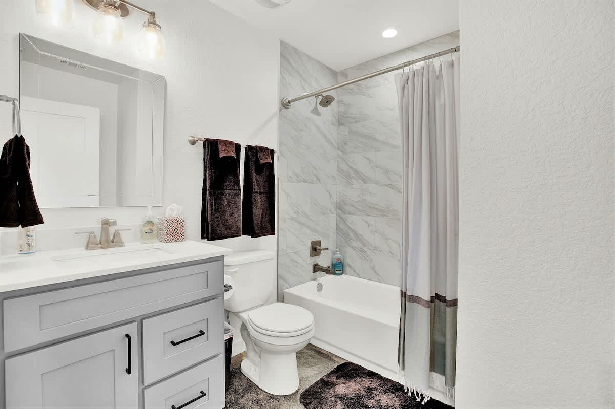 A sleek design shower-tub combo can be found in bathroom 2.