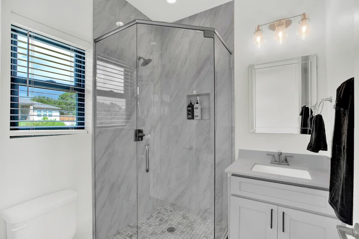modern and sleek glass shower of the luxurious master bathroom.