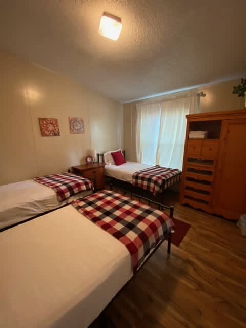 Main house - this room has 3 twin beds. No closet but does have a small armoire