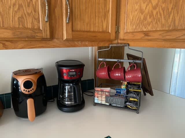 Main house kitchen has a coffee maker, air fryer, pots, pans, dishes, utensils and so much more