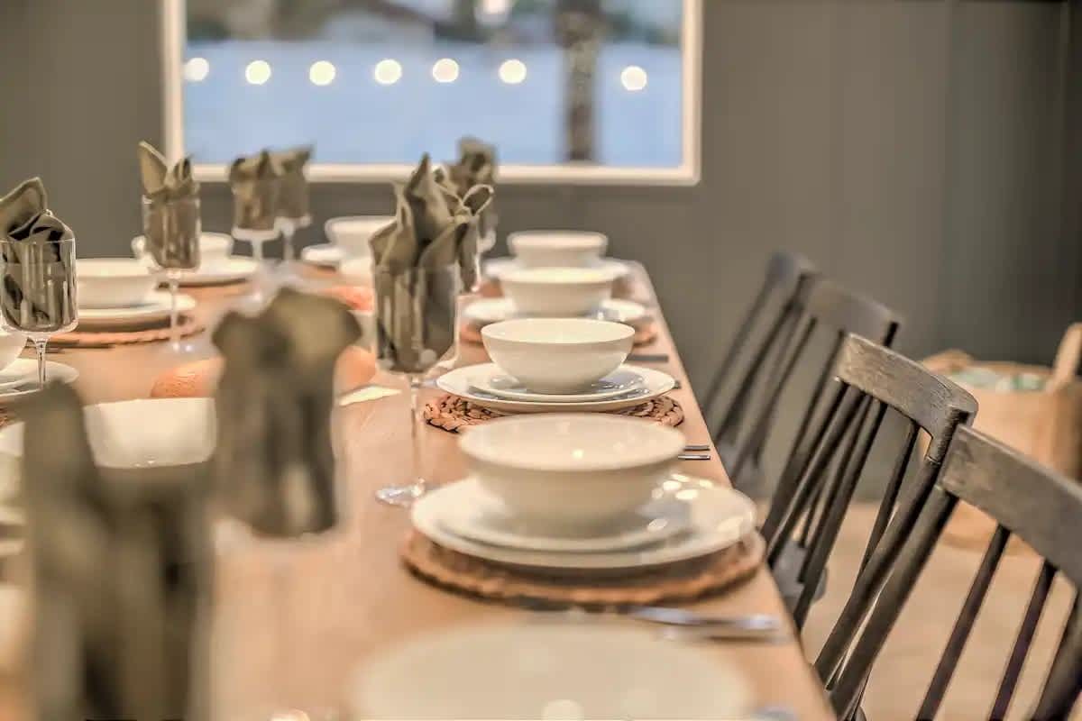 Gather around for memorable meals at this extended dining table set for a crowd — ideal for group dinners and celebrations.