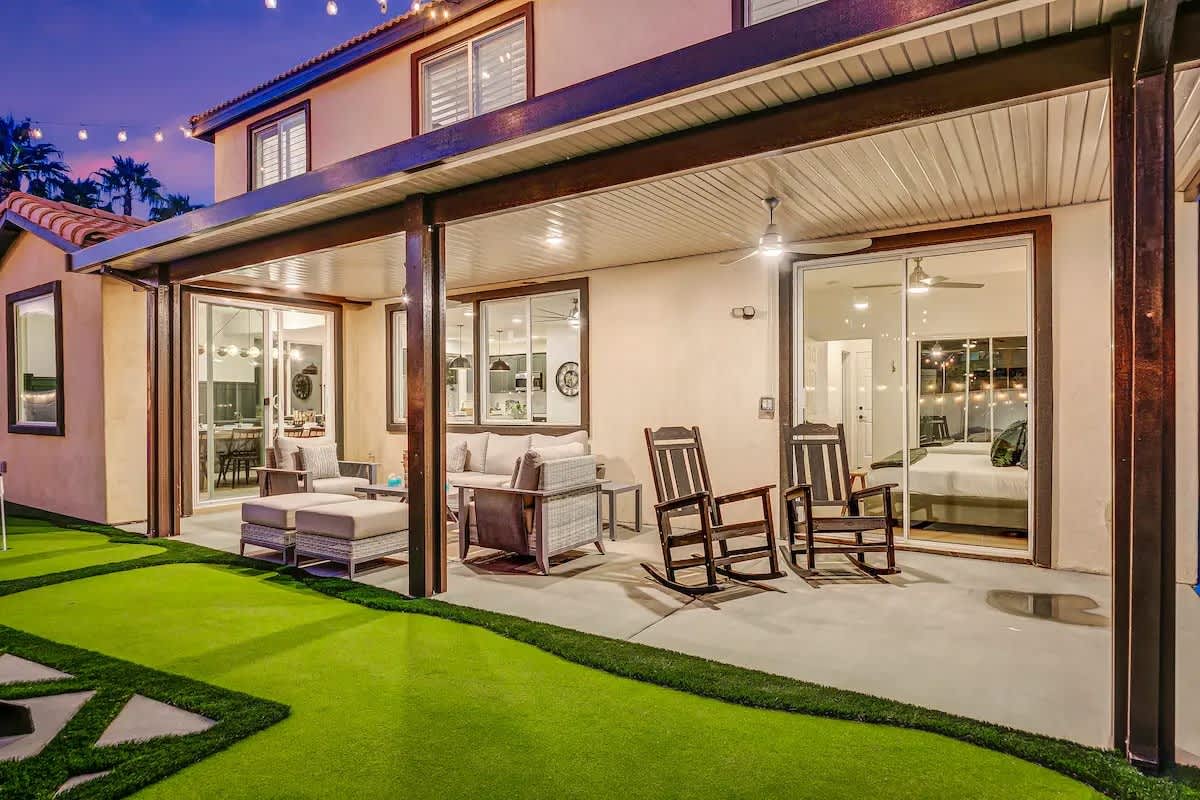 Step outside and relax under the twinkle of patio lights on this covered terrace, complete with cushioned chairs, rocking seats, and easy access to the indoor comforts.