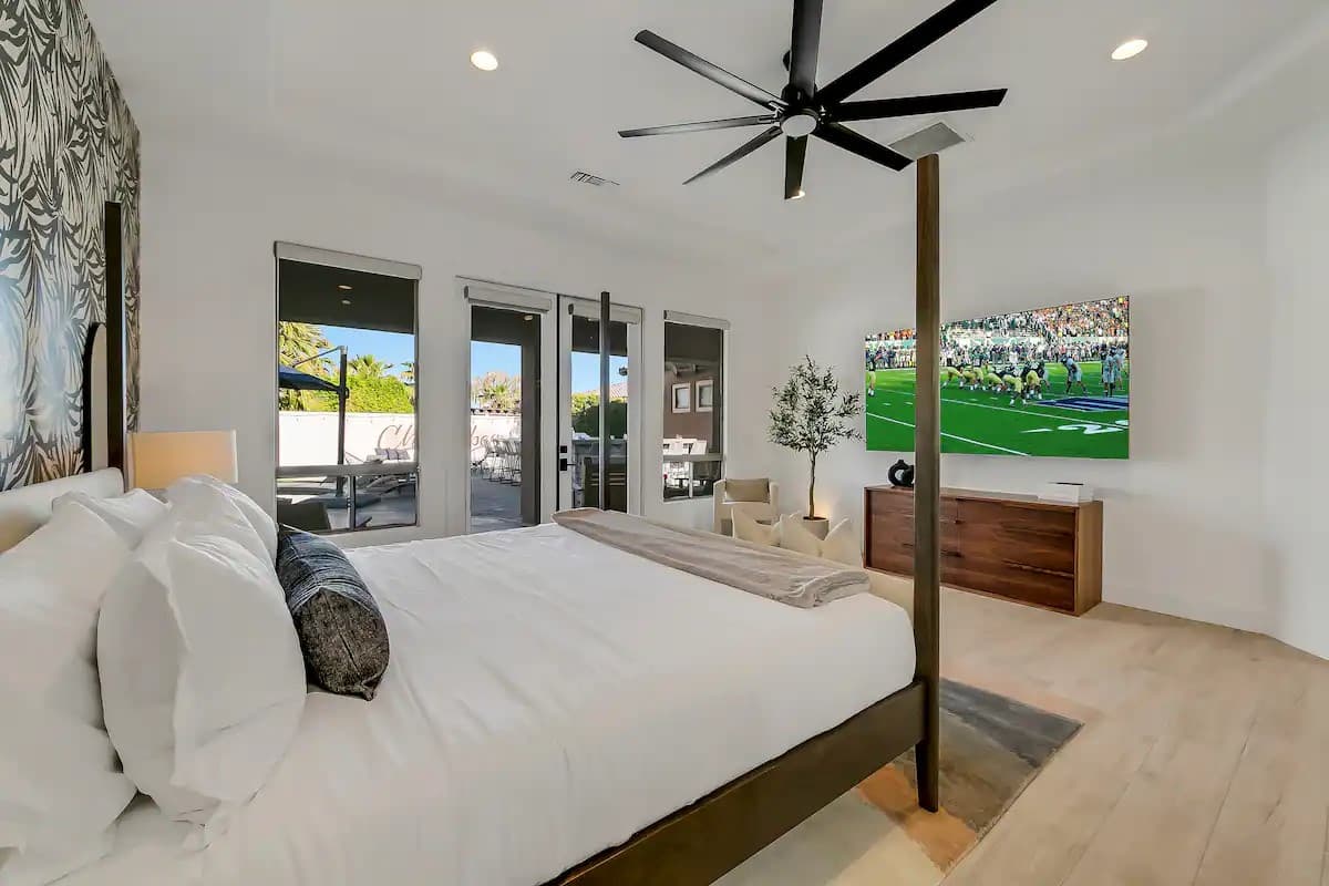 Description: Bright king bedroom with large sliding doors leading directly to the backyard for a seamless indoor-outdoor experience.