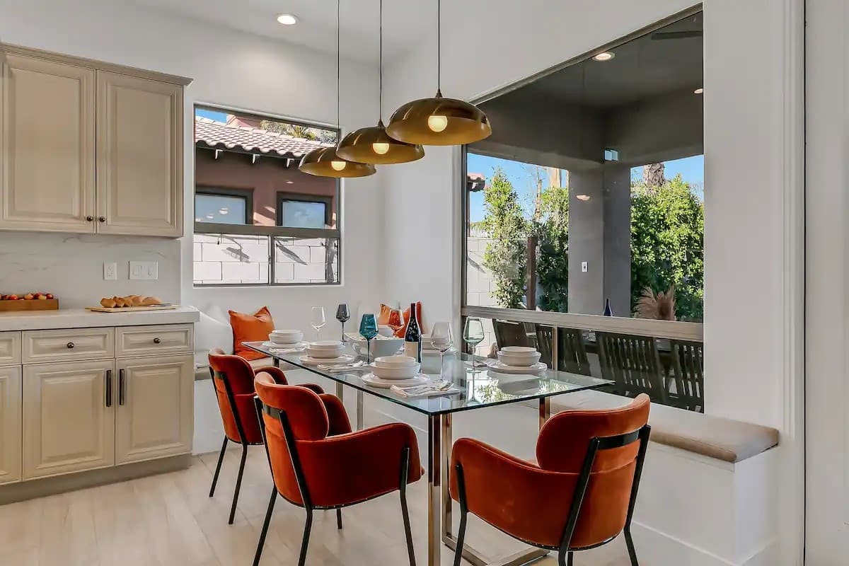 Enjoy morning coffee or intimate dinners in this stylish nook framed by large windows and contemporary lighting.