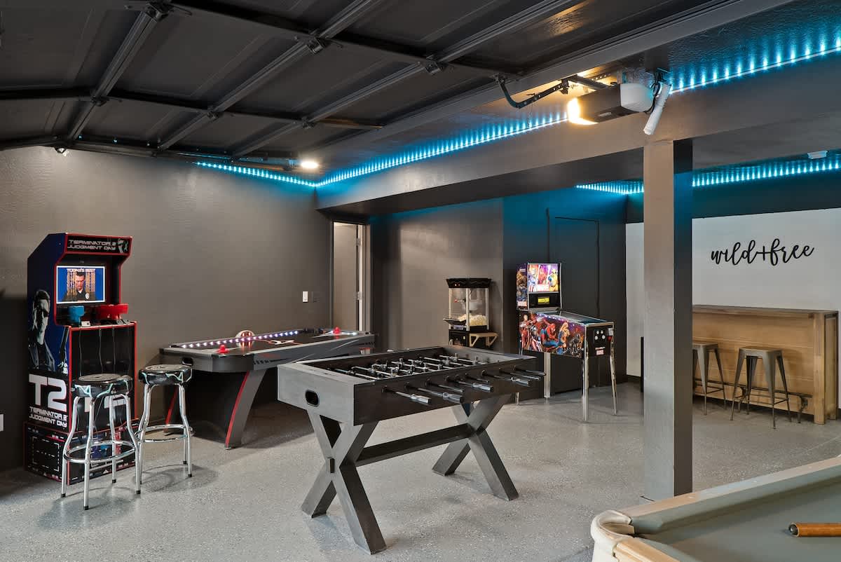 Gameroom with pool table, foosball, ping pong, shuffle board, arcades and more. Opens to the lower patio to let the fun flow inside and out.