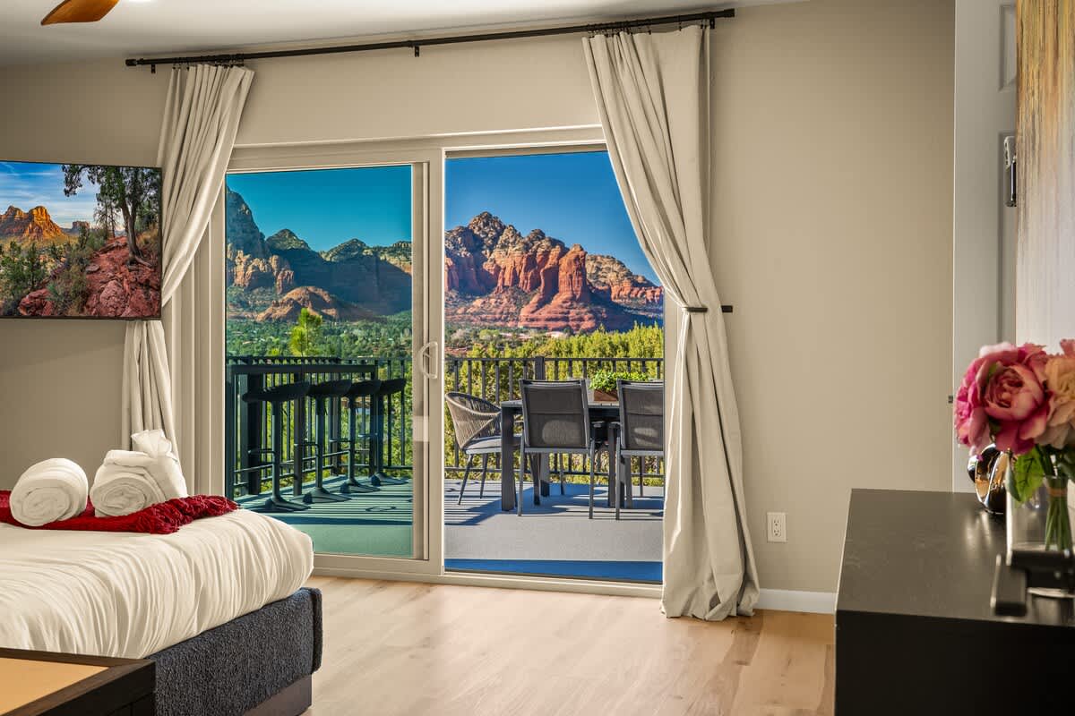 Primary suite with incredible views of red rocks and Thunder Mountain out the private slider to deck.