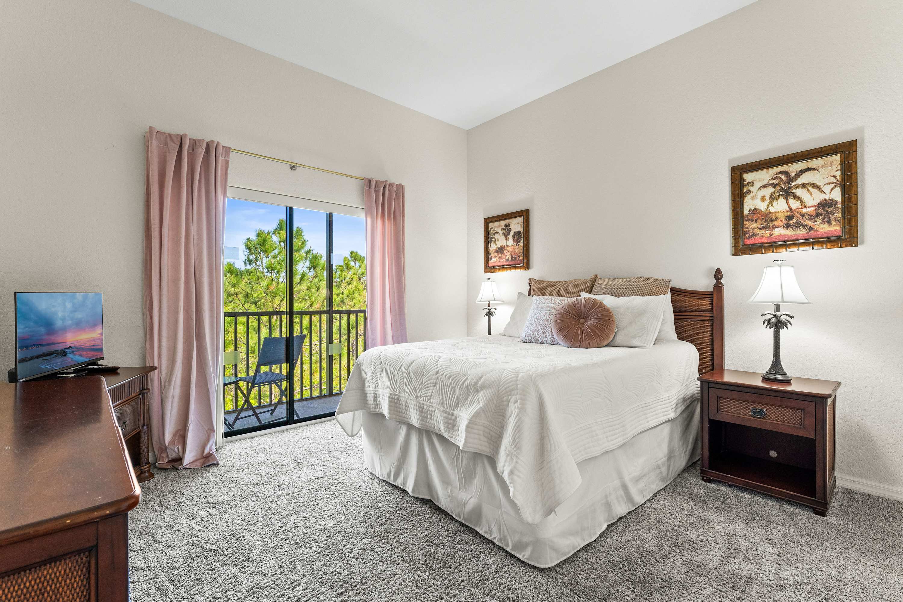 Recharge in this cozy queen bedroom, featuring balcony access