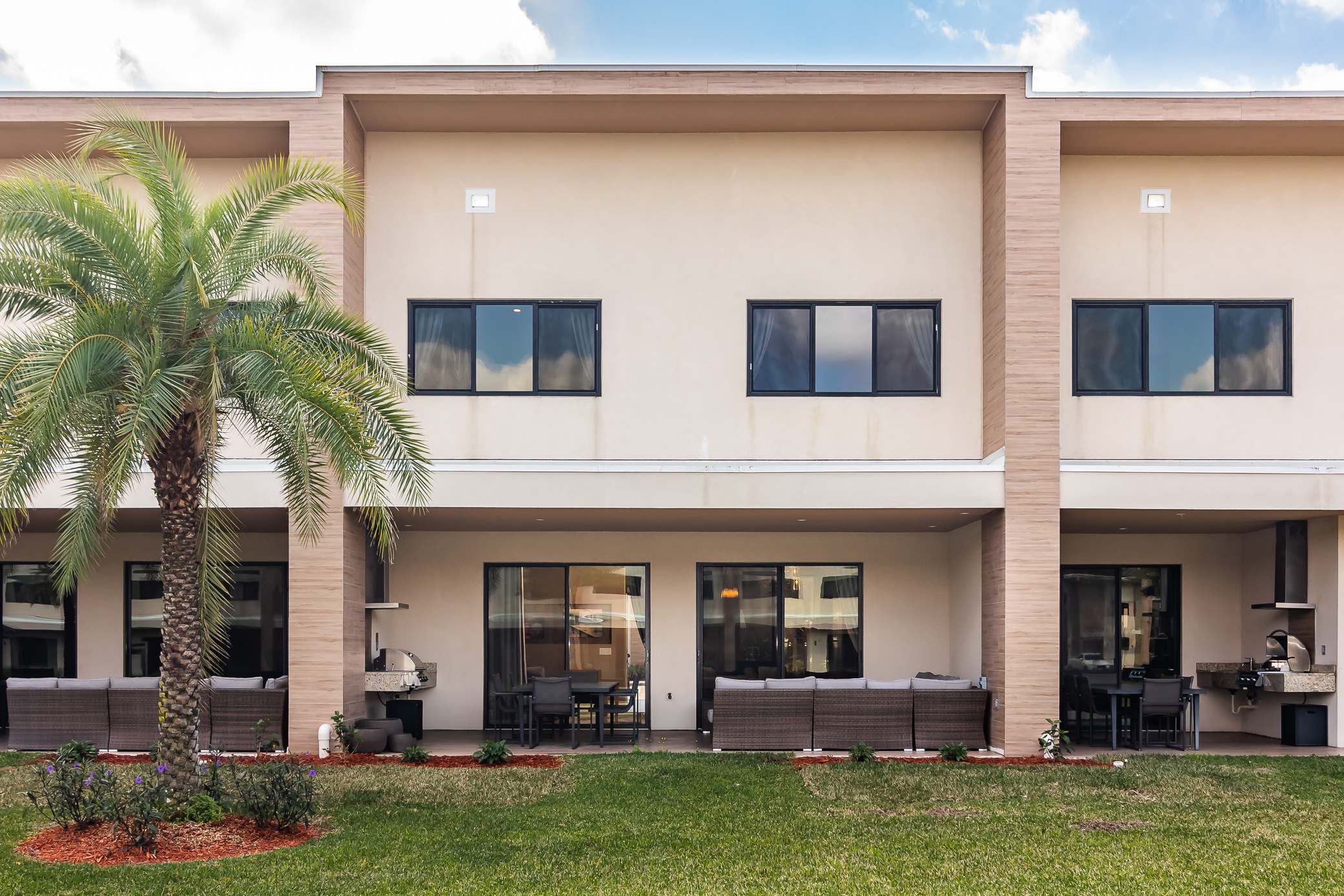 Patio with table, seating, and grill station