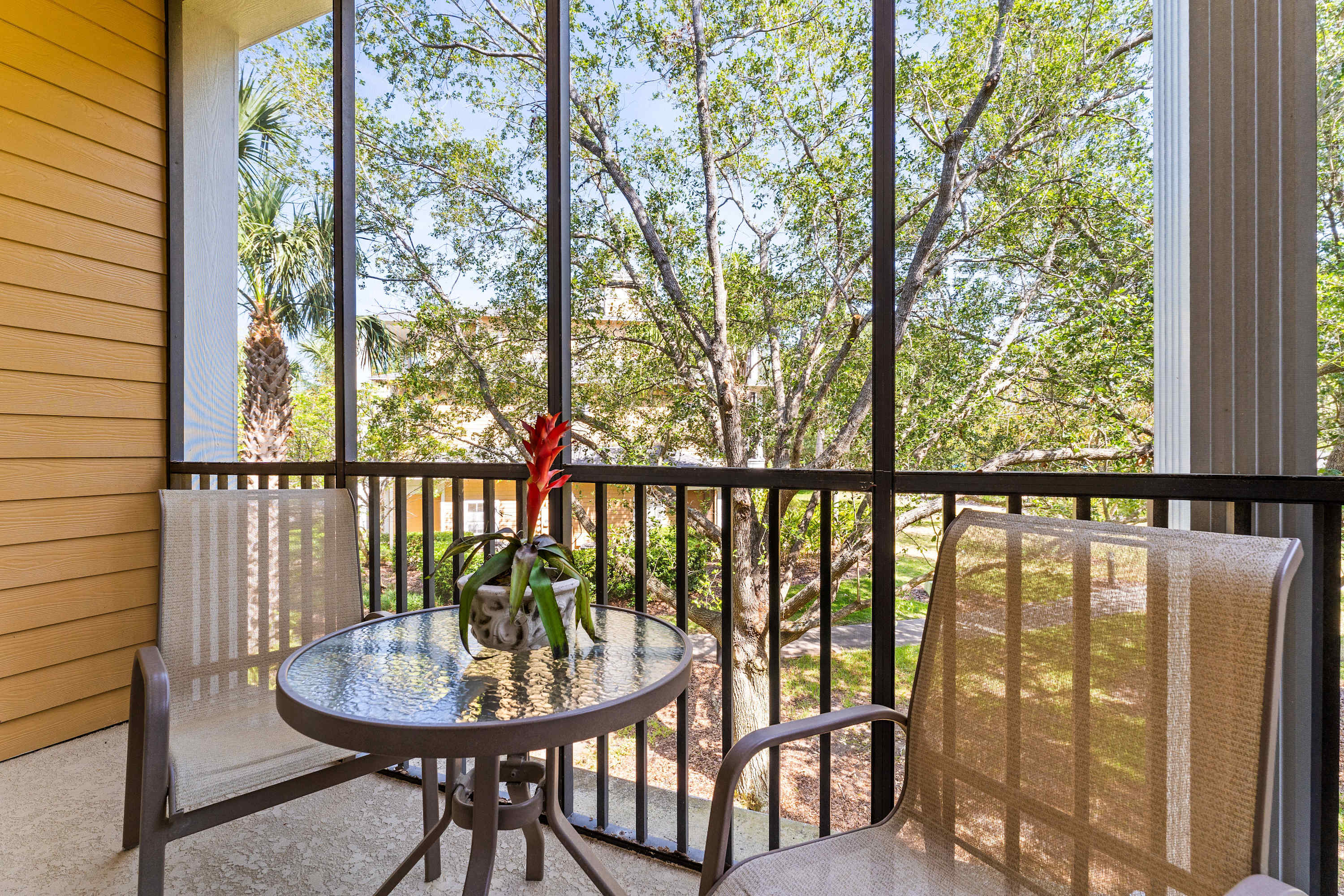 Screened balcony with two chairs, perfect for relaxing & enjoying the fresh air