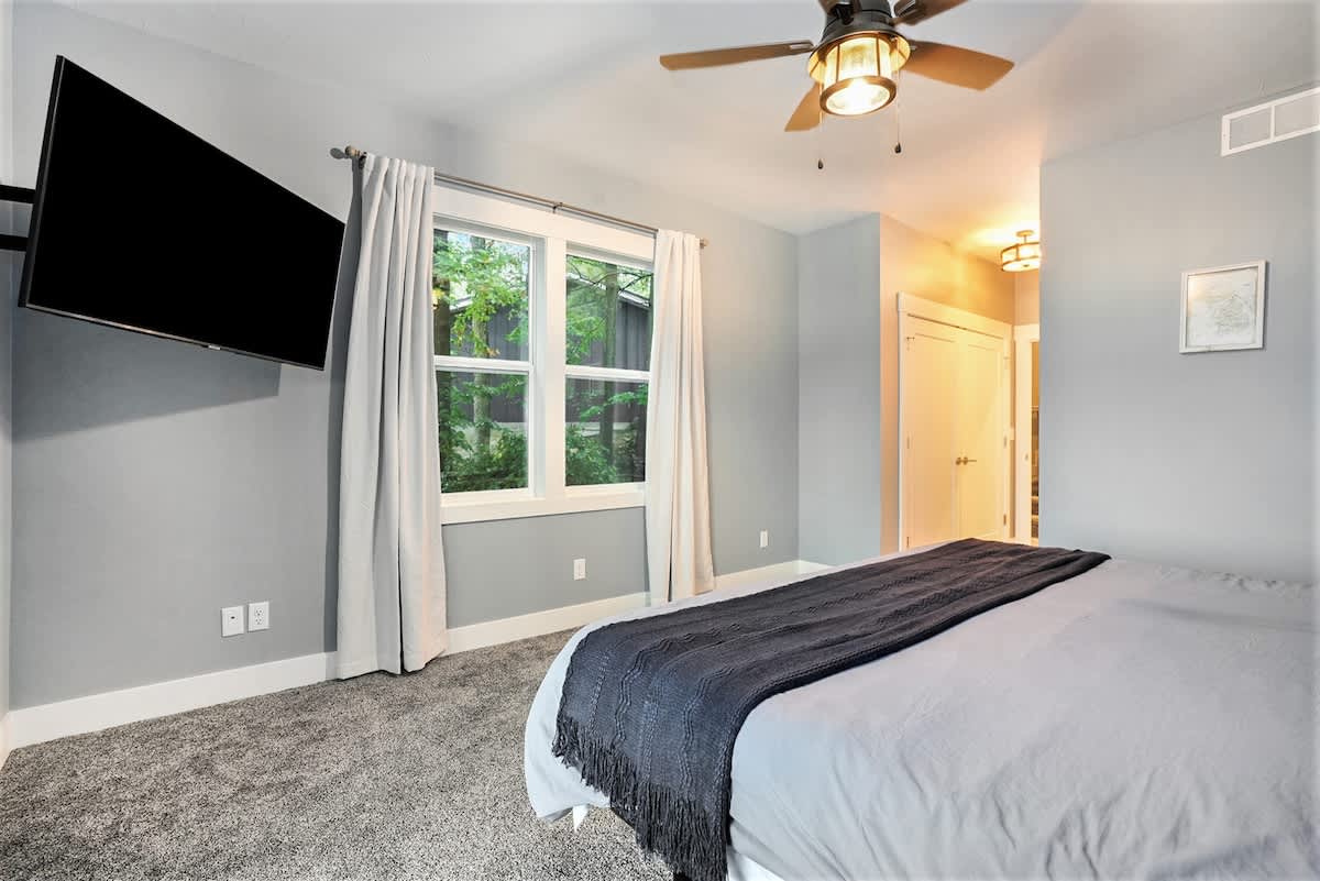 Unwind in the master suite, where comfort meets elegance and every window frames a picture-perfect lakeside scene.