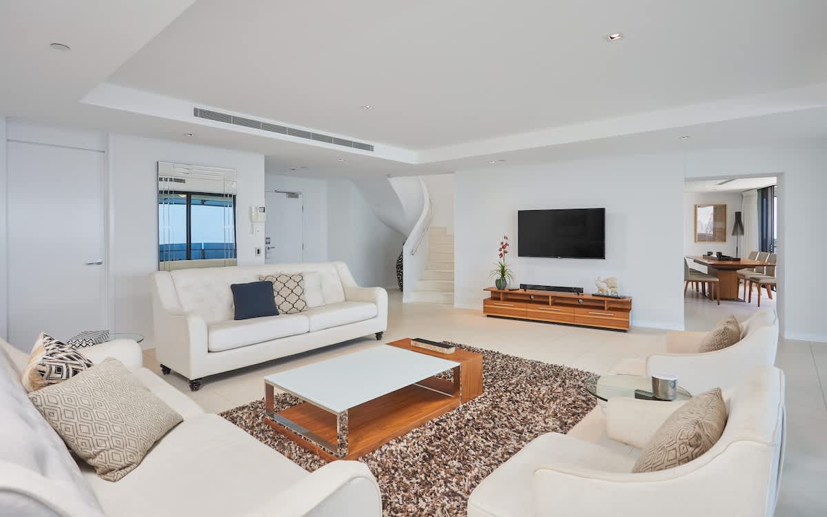 Main living area on level 41, with stairs to level 42, and access to the kitchen and dining. 