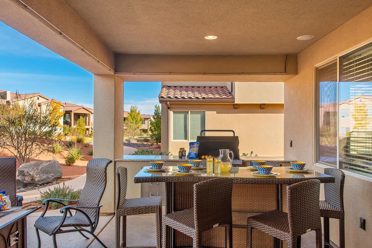 Patio with built-in BBQ, fire pit and dining table with chairs