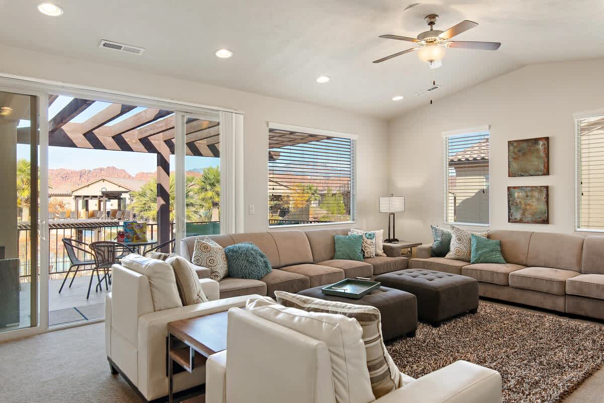 Upstairs living room with large sofa sleepers, balcony pool view