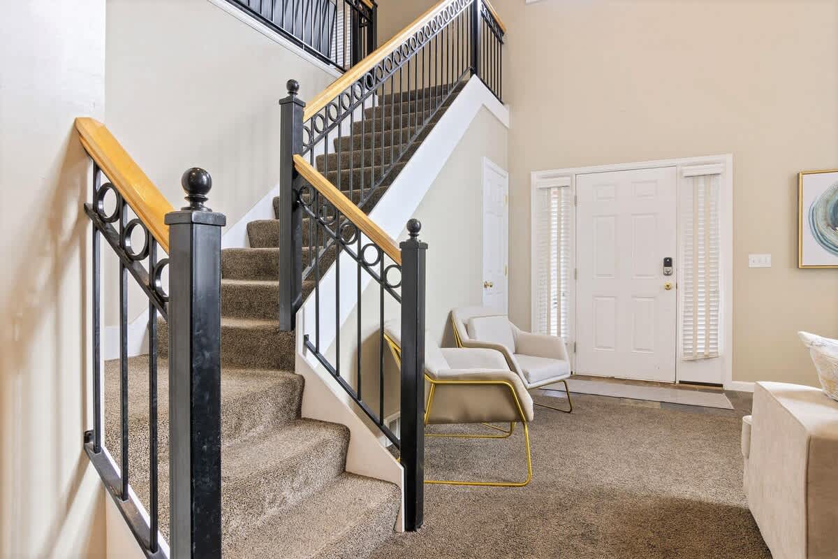 Great room has 2 additional chairs and open stairwell to loft