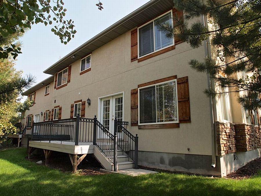Back deck and exterior surrounded by mature pines and aspens