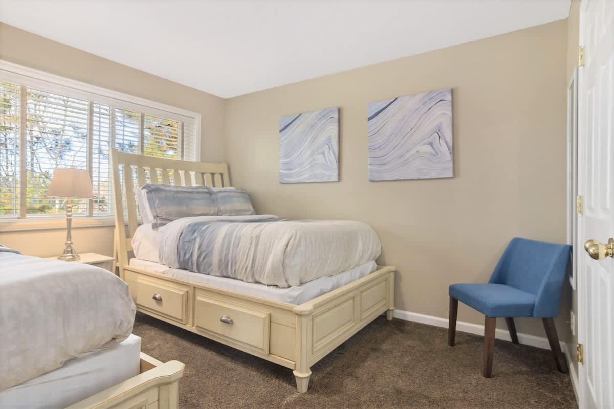 Bedroom 3 with 2 full beds and chair