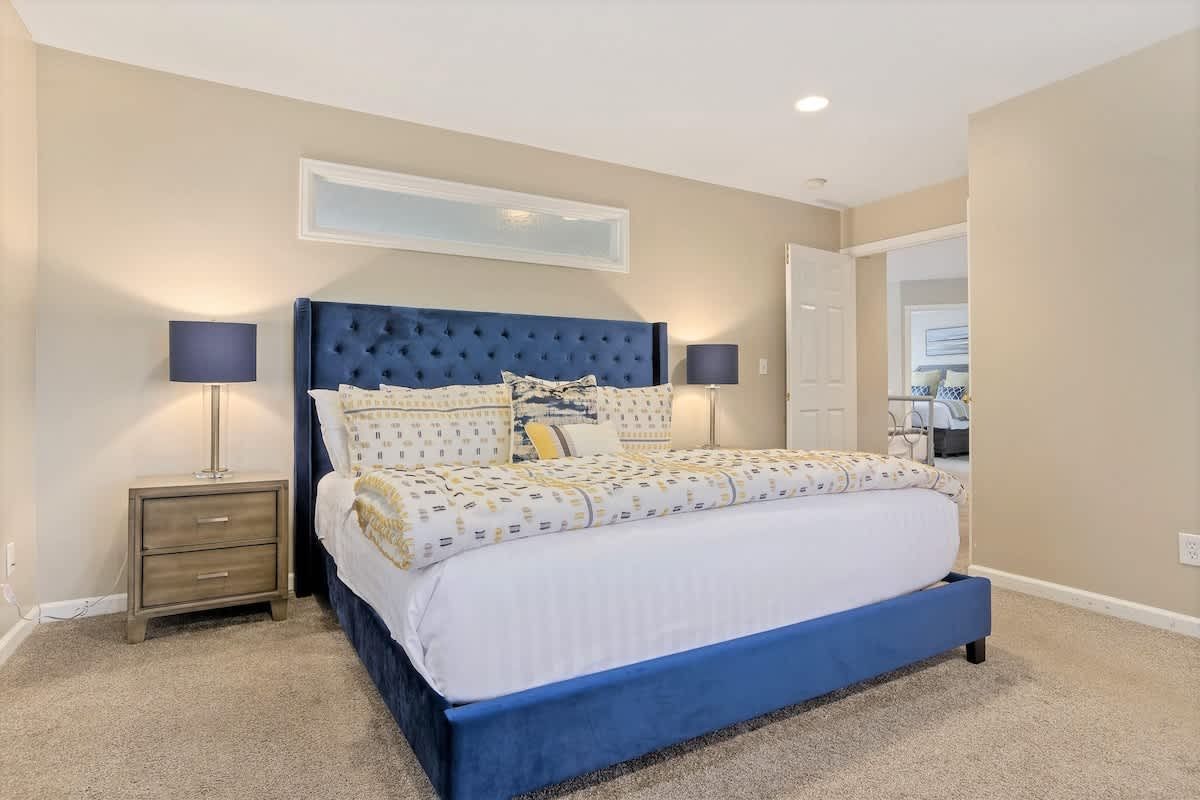 Master bedroom with gorgeous tufted king bed