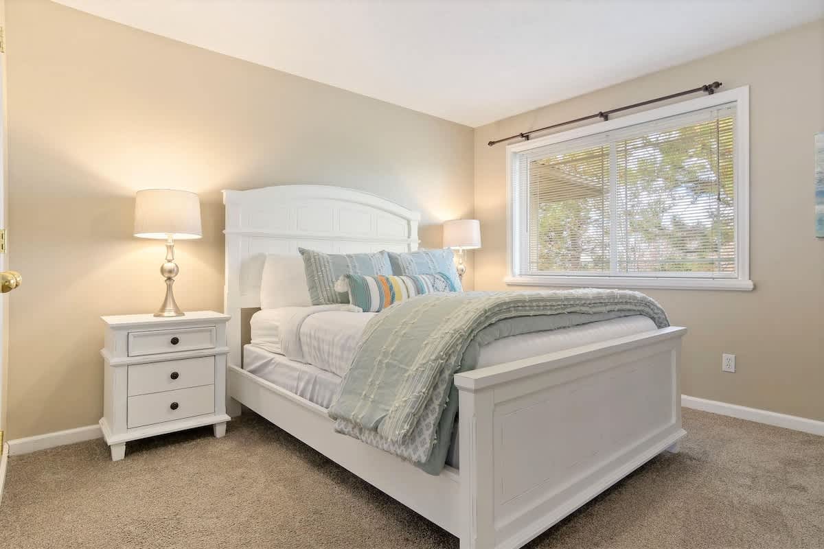 Bedroom 2 with beautiful white queen bed and luxury linens