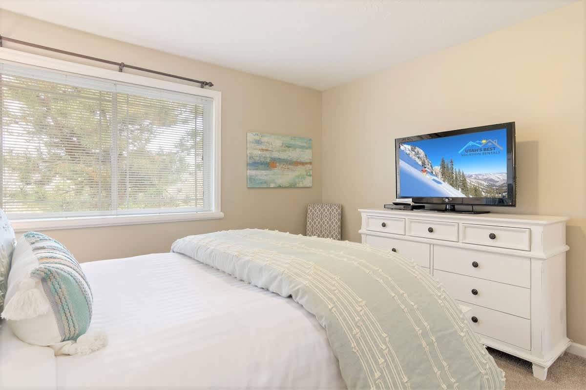 Bedroom 2 has a nice park view and TV with chair