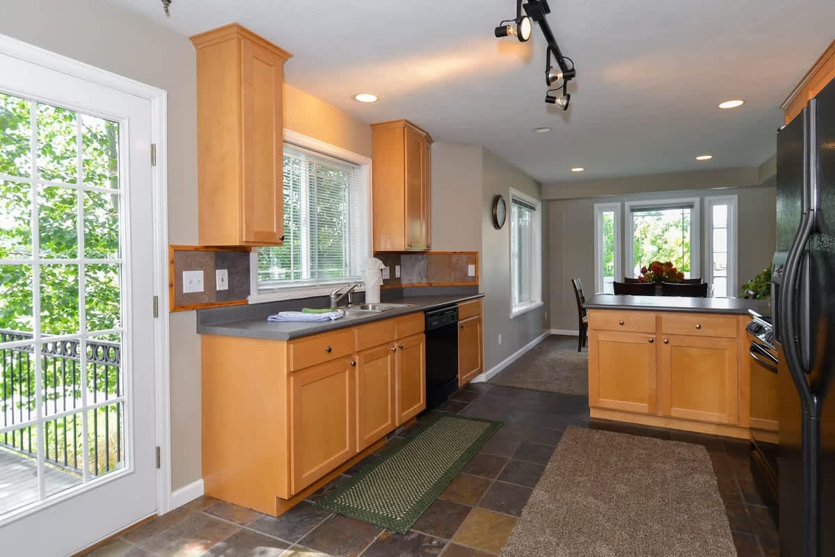 Open concept kitchen with door to deck and hot tub