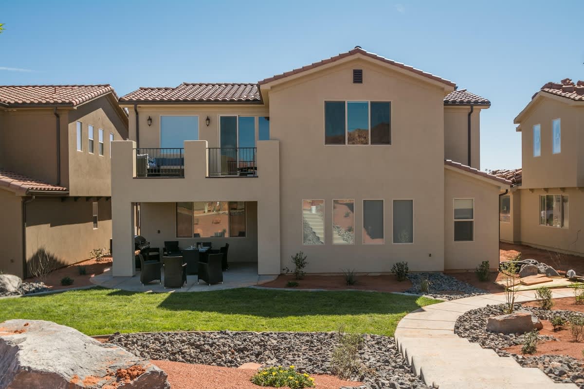 Back of the home, extended patio has a fire pit
