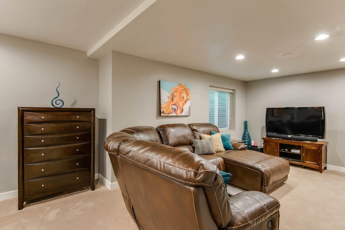 Basement recreation room with sectional and TV