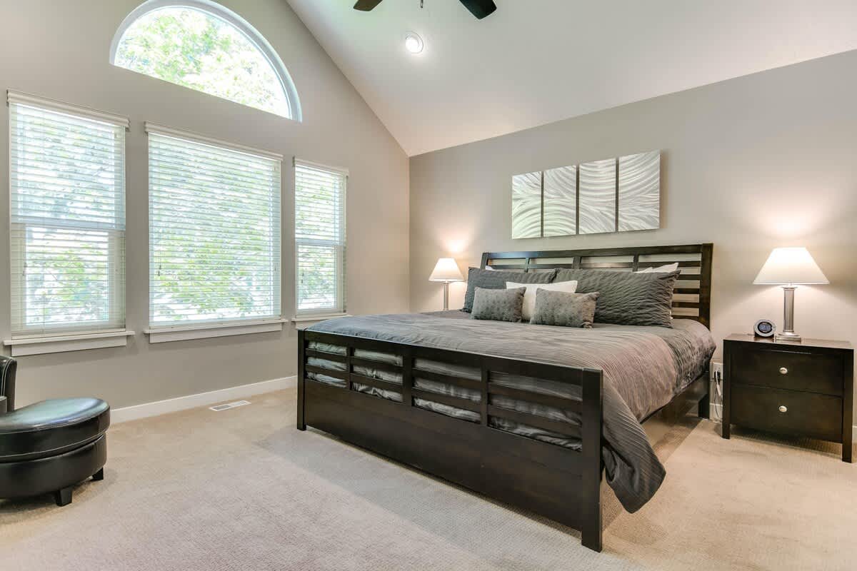 Master suite with king bed and vaulted ceiling