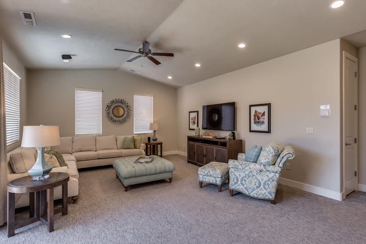 Family room upstairs with sectional sofa seating and large TV