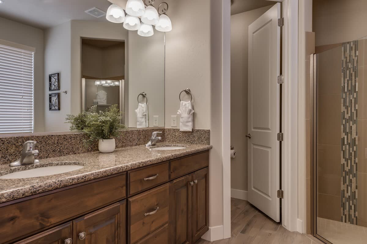 Master bathroom with double vanity sink and shower