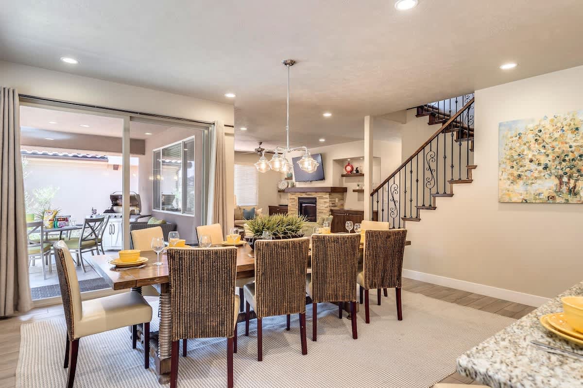Large dining table and covered back patio with BBQ and table