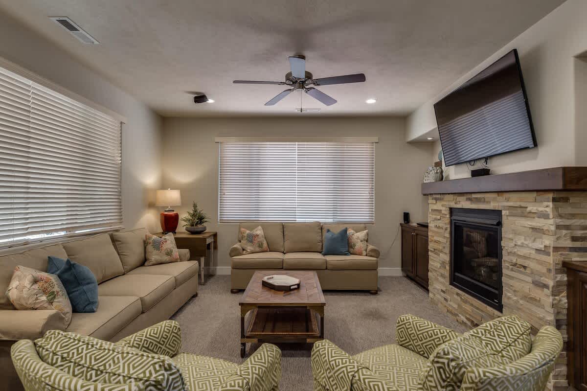 Comfortable family room with ample seating and fireplace and TV