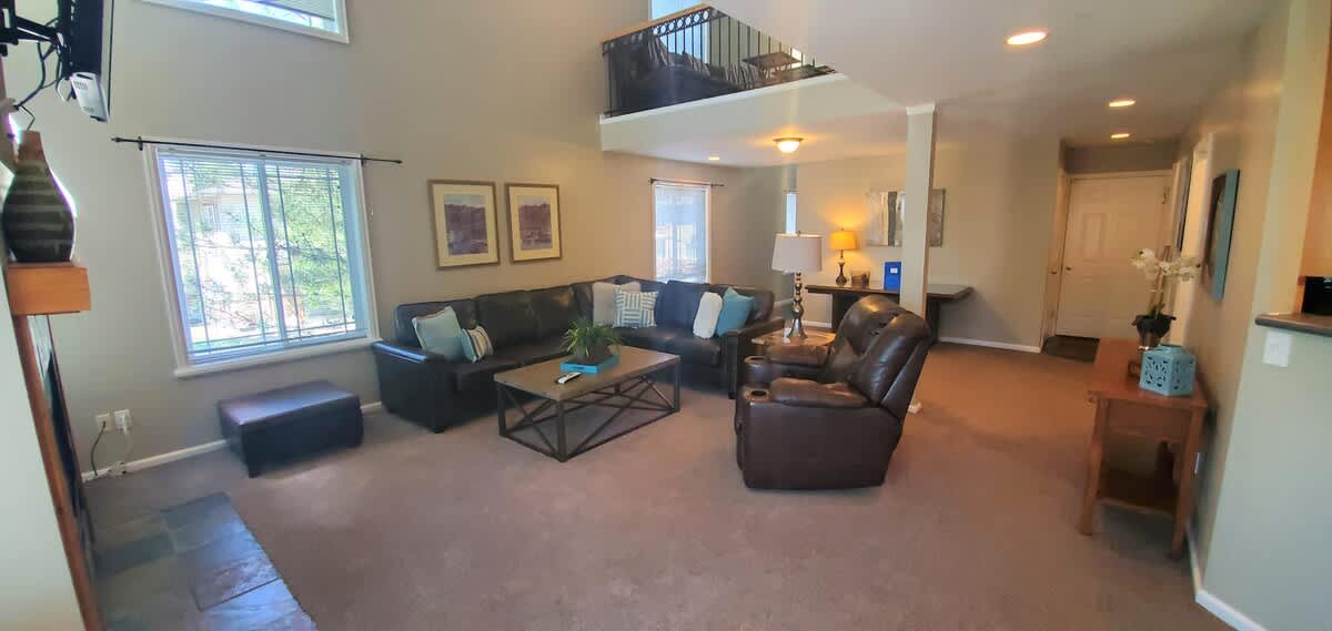 Open great room with comfortable leather sofa and recliner