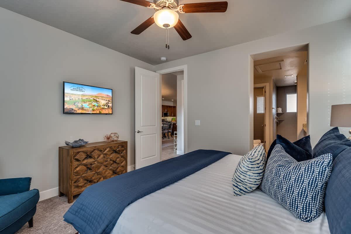 Master bedroom on main level with king bed and TV