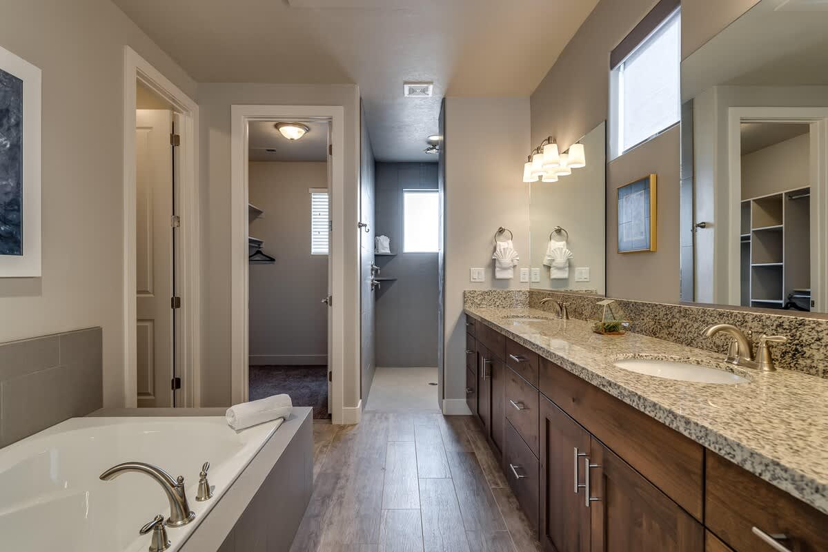 Master bathroom with dual sinks, walk-in shower and garden tub