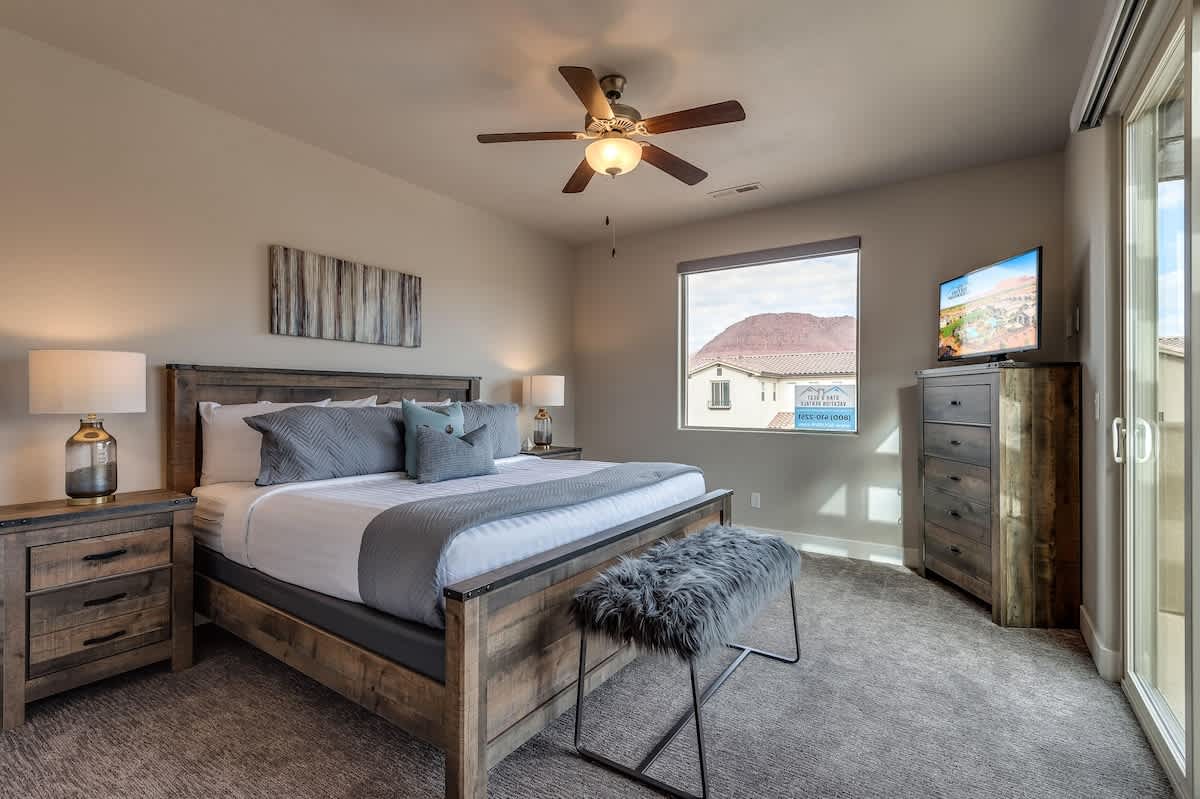 Master bedroom 2 upstairs with king bed, TV, and balcony