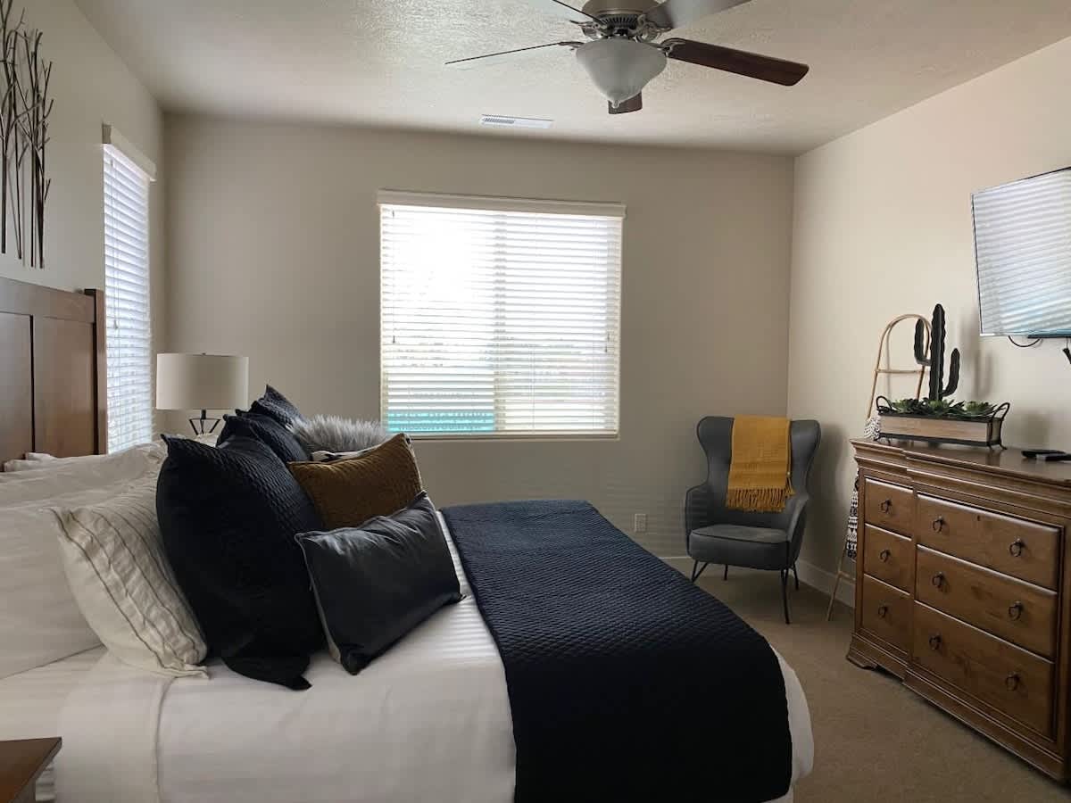  Master Bedroom 1 with sitting chair and large TV
