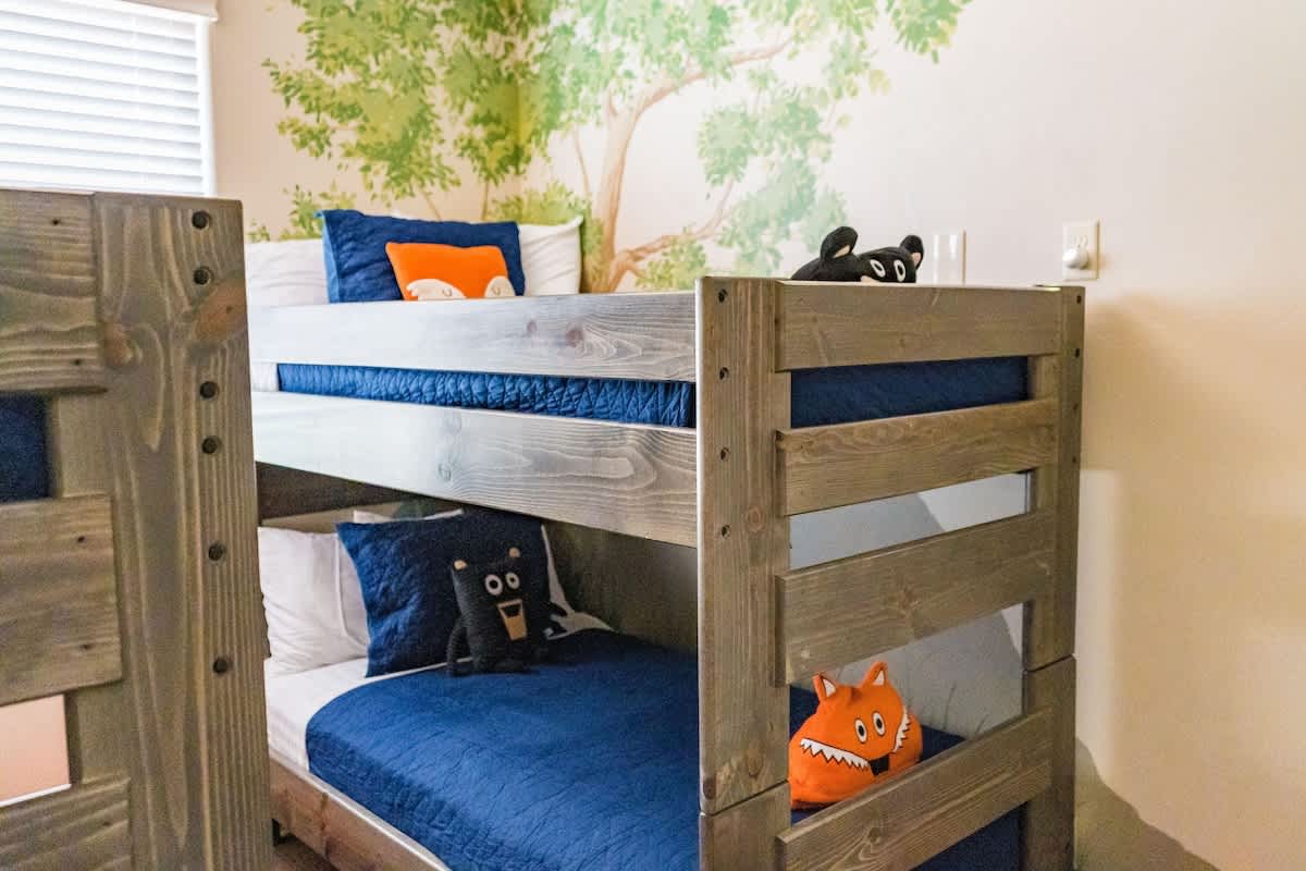 Bunk room sleeps 6 with a small smart TV and walk-in closet