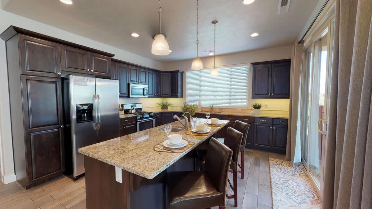 Fully stocked kitchen has a large island with seating for 3, 2 sinks, reverse osmosis drinking water and deluxe appliances