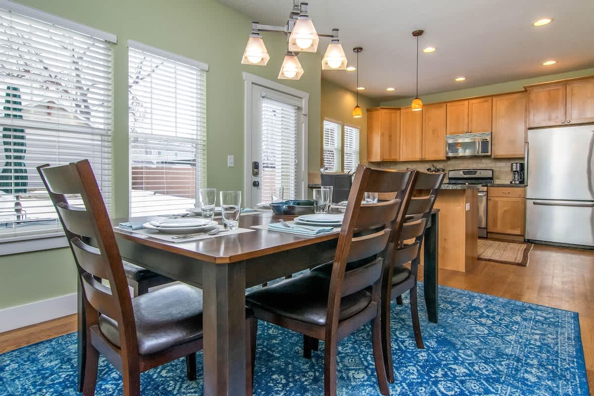 Open concept kitchen and dining area with table seating for 6