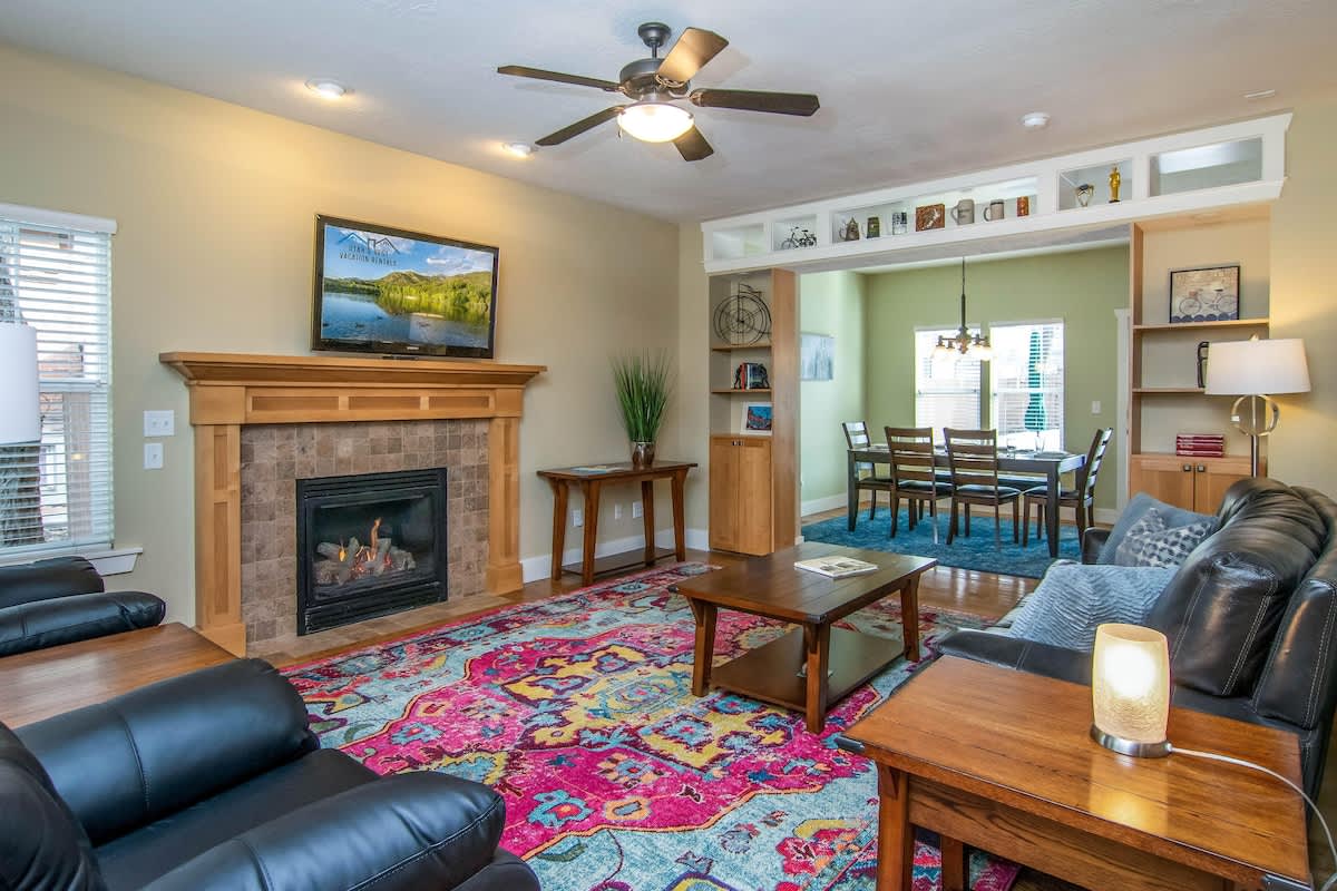 Beautiful cozy living room with fireplace, TV, and sofas