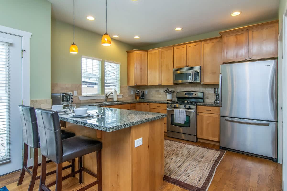 Kitchen with bar seating and beautiful wood floors